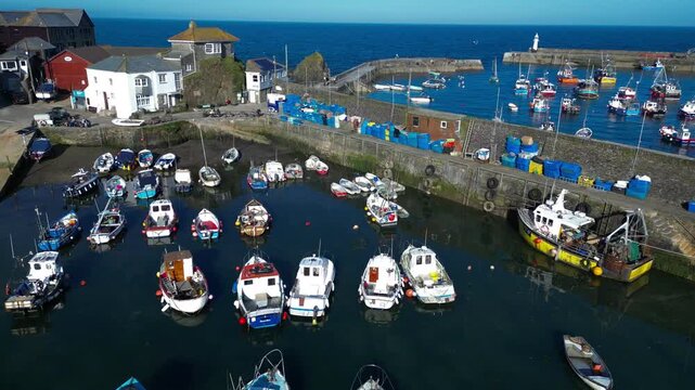 Aerial views of the harbor in the costal village and port of Mevagissey on the south coast of Cornwall in the southwest of England.