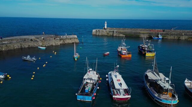 Aerial views of the harbor in the costal village and port of Mevagissey on the south coast of Cornwall in the southwest of England.
