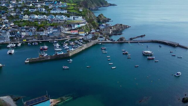 Aerial views of the harbor in the costal village and port of Mevagissey on the south coast of Cornwall in the southwest of England.