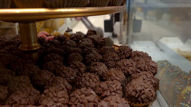 Closeup of a chocolate fudge ball in the window of a Brazilian bakery.
