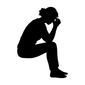 Silhouette of a person sitting with head in hands, expressing sadness and despair