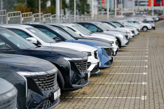 Minsk, Belarus. Aug 20, 2025. Huge fleet of new cars lined up in an outdoor paved parking lot at an automotive distribution center ready for sale, auto industry market and business commerce