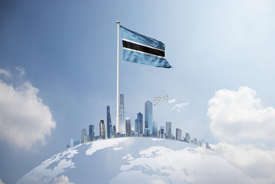 Botswana flag wavering on globe with modern building skyline. Flag waving on world map.  Botswana national flag for independence day.