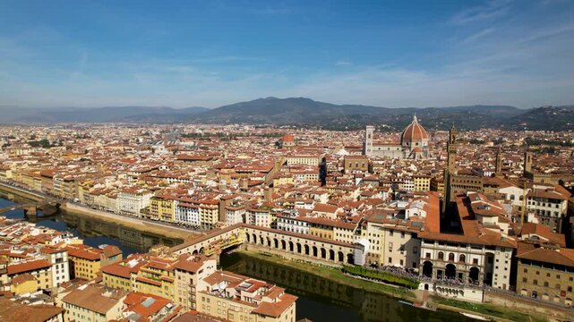 Italy Florence aerial 4K drone cinematic Ponte Vecchio Duomo Arno reflection historic town center Uffizi gallery buildings cityscape skyline tuscany travel tourism destination overflight footage