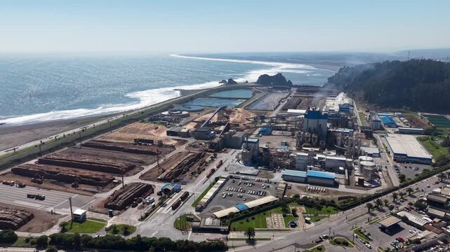 Aerial drone panning shot of Arauco cellulose plant on the coastline of Constitucion, Chile.