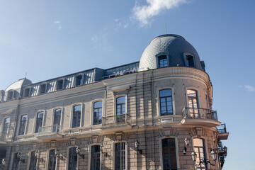Stunning classical architecture with dome and balconies under clear blue sky. Ideal for urban or architectural projects © Kathrine Andi
