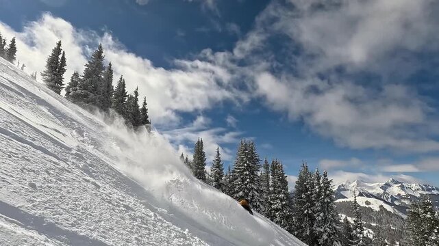 Snowboarder in powder in Telluride Colorado during a bluebird day 