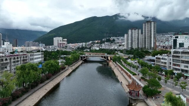 Dali Yunnan riverfront cityscape with Cangshan Mountains in Dali, Yunnan, China