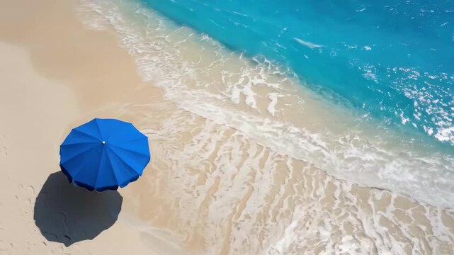 Serene beach with blue umbrella on sandy shore and turquoise waves
