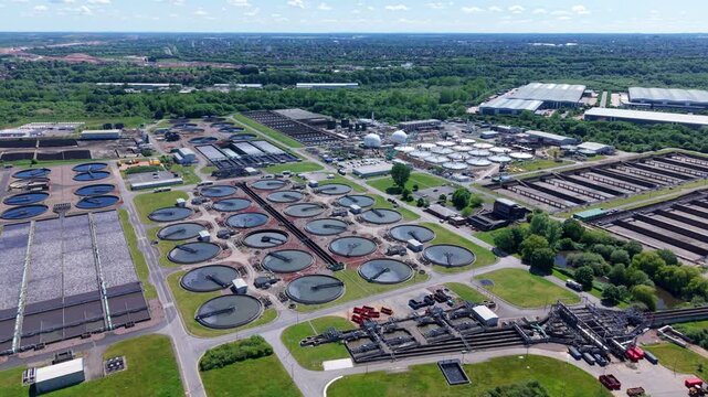 Birds eye view of a large municipal wastewater processing facility with circular sediment tanks