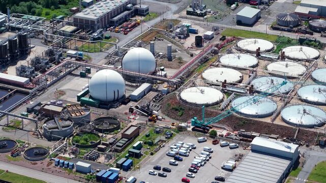 Close up aerial drone shot of massive circular anaerobic digestion domes at Minworth wastewater treatment plant UK