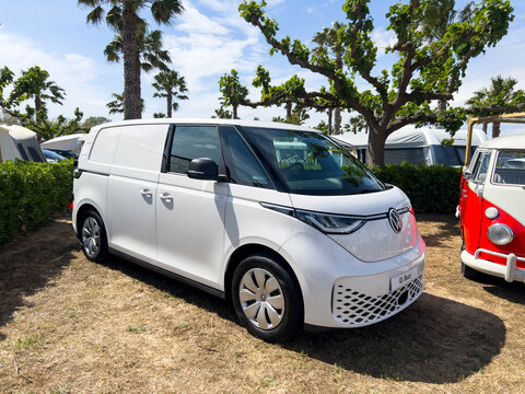 Sant Pere Pescador, Spain; May 20 2023: The microbus and camper Volkswagen T1 Kombi and new electric ID Buzz at an exhibition in camping