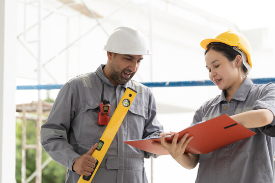 Building house or residential building. Team of Construction worker or technician discussing and inspecting structure of building or Check safety of scaffolding at construction site