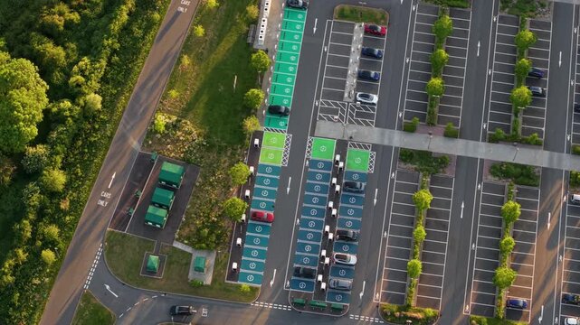 Close Up Aerial View of an Electric Vehicle EV Charging Car Park with Rows of Ultra Rapid Chargers and Cars at Rugby Services Station on the M6 UK