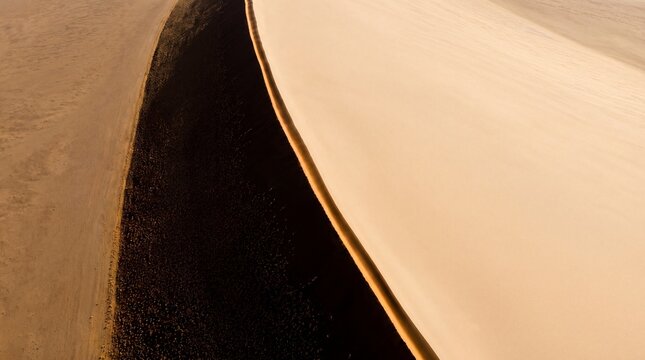 Aerial view of sand dune with contrasting shadows