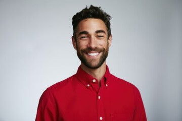 Obraz premium The Red Shirt Portrait of a Smiling Man in Studio Lighting