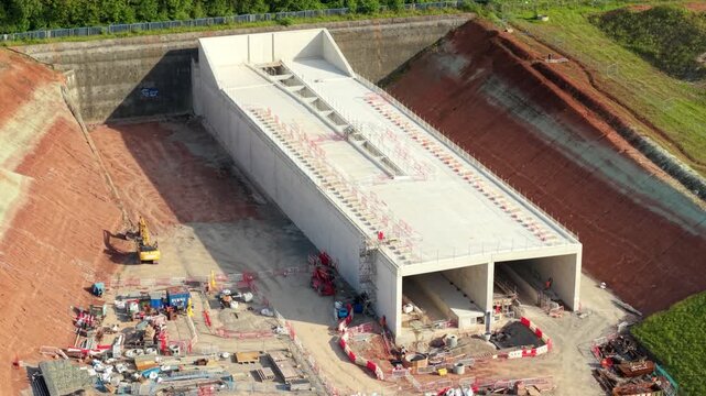 Drone shot of the Long Itchington Wood tunnel portal structure cutting into the earth beneath an ancient forest near Southam