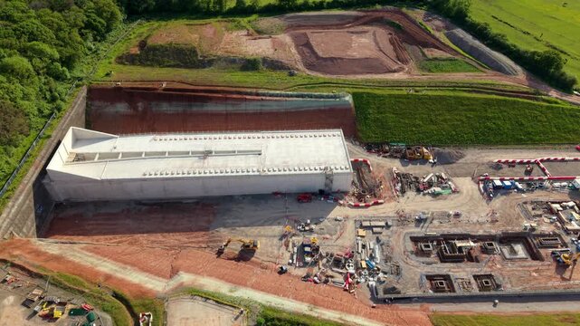 Drone shot of the Long Itchington Wood tunnel portal structure cutting into the earth beneath an ancient forest near Southam