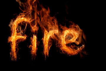 Fototapeta premium Burning fire lettering glowing with bright orange flames on deep black background and dramatic heat effect
