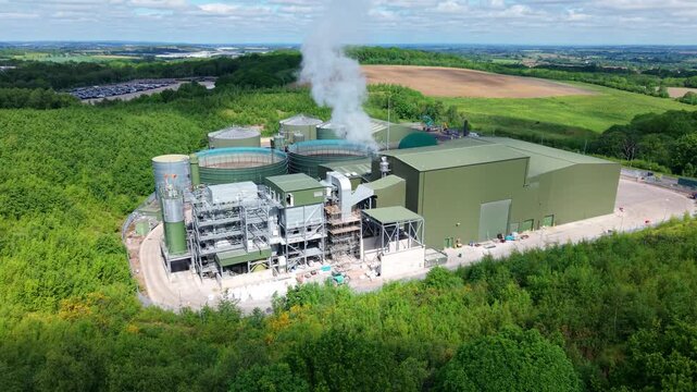 High angle aerial drone view of a large anaerobic digestion facility producing biogas and renewable electricity for the national grid near Atherstone Warwickshire UK