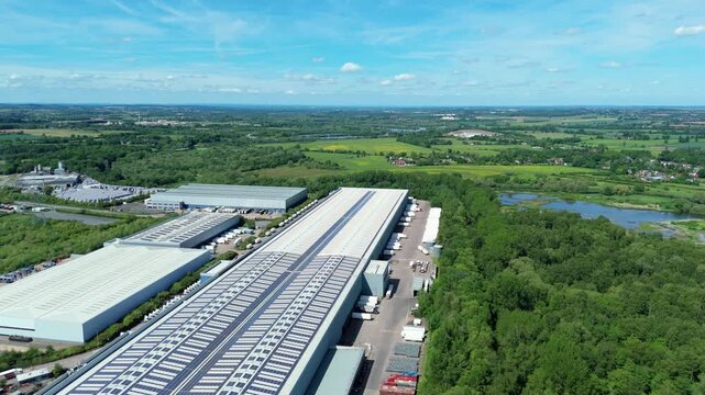 High angle drone view of a large commercial transport hub showing freight truck parking and distribution yard layouts.