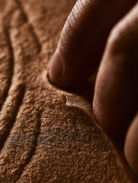 Finger hand skin macro closeup texture brown paper fiber wrapper touch peel seal biodegradable ecofriendly soft warm ambient light natural line wrinkle detail surface fabric absorbent hygiene