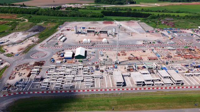 Drone shot of thousands of concrete railway components stockpiled at an industrial infrastructure factory yard near Birmingham
