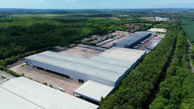 High angle drone view of a large commercial transport hub showing freight truck parking and distribution yard layouts.