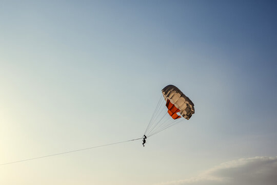 Extreme tourist parasailing in the sky during summer vacation