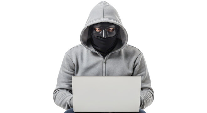 A hooded hacker wearing a mask while working on a laptop computer screen