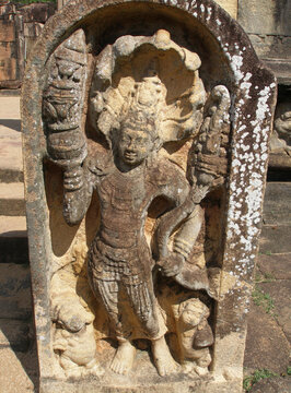 Ancient stone guardstone Muragala depicting a Dvarapala guardian with a multi-headed cobra hood, Sri Lanka