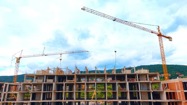 High-rise apartment building structure with concrete formwork system. Unfinished concrete upper floors of a residential high-rise building with safety structures.