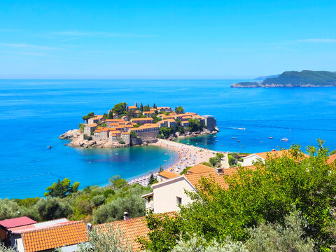 Aerial view of Sveti Stefan island resort in Montenegro. Beautiful Adriatic sea and luxury beach at sunny summer day.