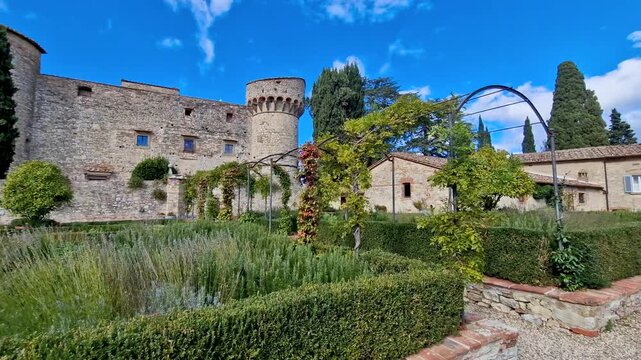 Meleto Castle view in Chianti wine region Italy with blooming lavender gardens. Cinematic historic Tuscan castle details with green vineyards and stone architecture. Travel scenic footage.