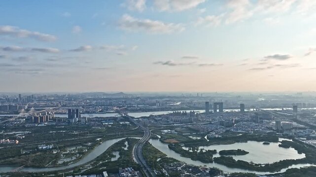 Suzhou Jiangsu China city skyline with lakes and highways at sunset