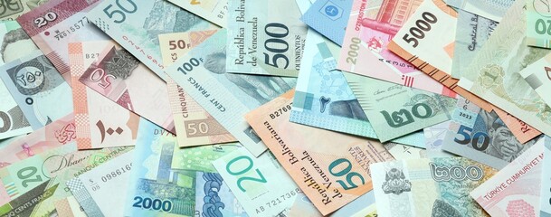 Fototapeta premium Big amount of money bills of various currencies. Assortment background of international cash