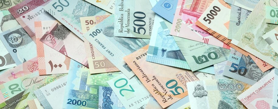 Big amount of money bills of various currencies. Assortment background of international cash