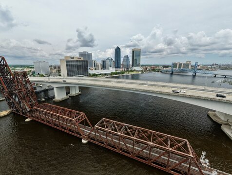 Aerial view of Northbank Riverwalk Brooklyn and the Jacksonville skyline with the Acosta Bridge and FEC Railway Bridge over the St. Johns River Jacksonville, Florida, United States.