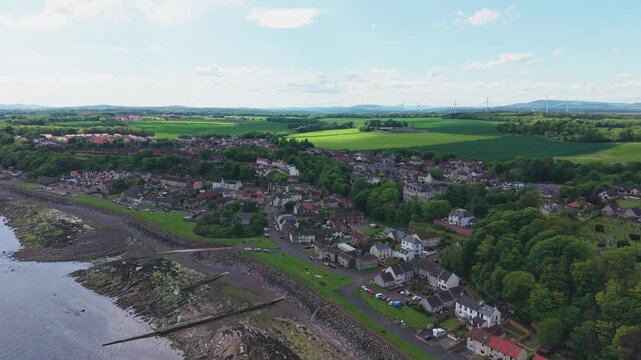 Aerial view of the coastal town of East Wemyss in Fife, Scotland. A wide panorama featuring the seaside village, traditional Scottish architecture, and the rocky shore of the Firth of Forth.