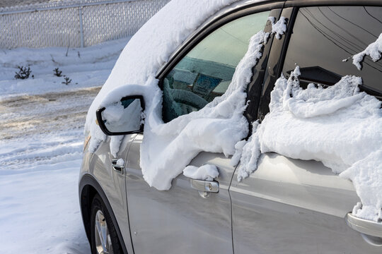 Canada, 25 January 2026 : Car covered in snow in winter parking lot