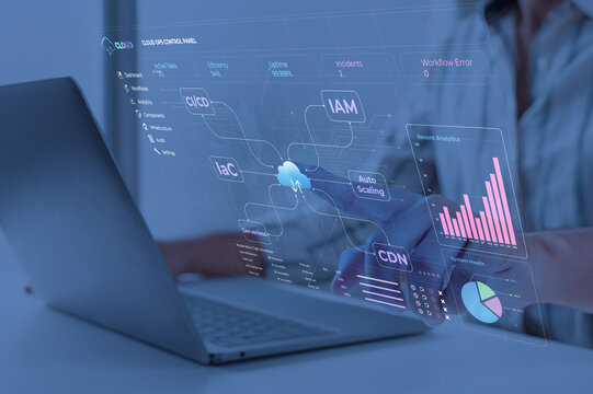 Digital cloud operations dashboard displayed on laptop in futuristic blue-lit workspace