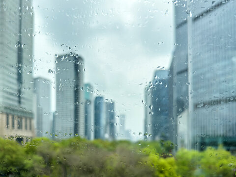 Rain speckled window with blurred high rise skyline in a China city