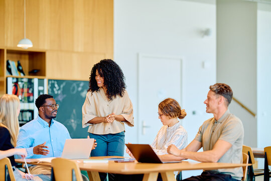 Diverse business professionals having a productive meeting, discussing strategy and working together in a modern office environment