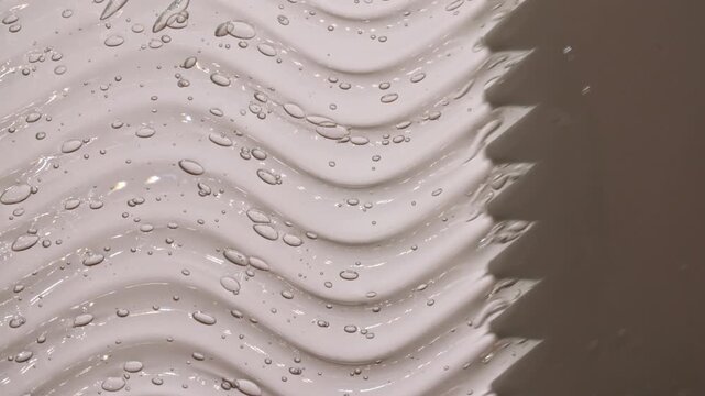 Applying clear gel with a spatula. Skin care light creamy cosmetic beauty product smudge closeup video. Cream texture footage. Skincare cosmetics sunscreen lotion mousse close up. 4k