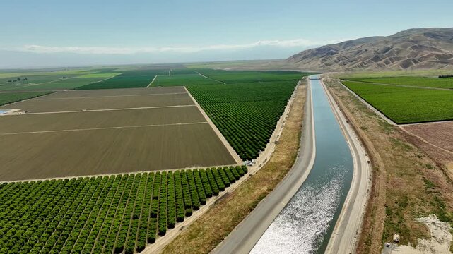 Aerial of farms along an aqueduct running through California's Central Valley north of Los Angeles.