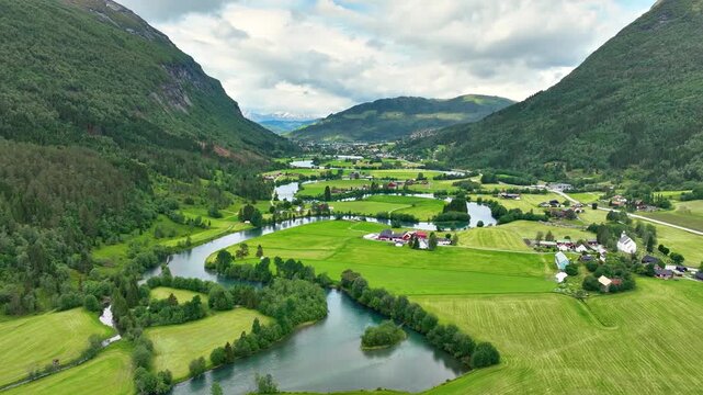 Aerial of a river winding through meadows and farmland near the town of Stryn Norway.