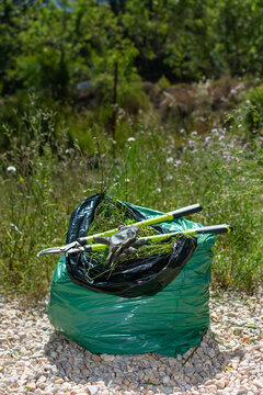 Vertical close up of garden waste bag with pruning tools