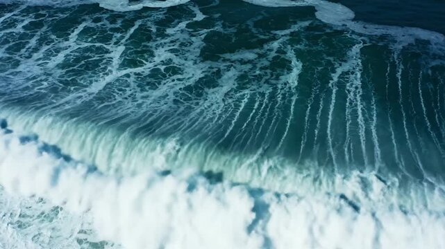 A powerful ocean wave crashes against the sandy shore in a scenic coastal view
