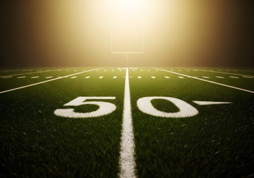 Football field end zone with sunrise lighting and fifty yard line marking at dawn