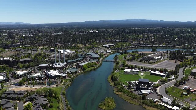 Aerial of downtown Bend Oregon Deschutes River and flag pole in Pacific Northwest in spring
